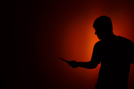 Silhouette Of A Man With A Knife.