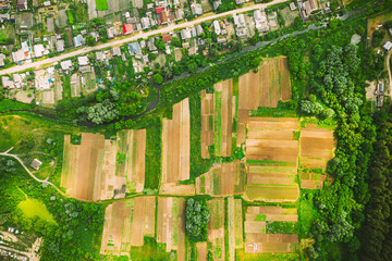 Aerial View Of Vegetable Gardens In Small Town Or Village. Skyline In Summer Evening. Village Garden Beds In Bird's-eye View