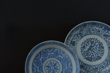 Lay out of picture plate. This is a very fine example of Japanese traditional antique “ imari ware ”.  black background・dim lighting image.