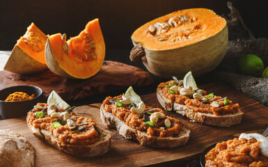 Toasted bread bruschetta with vegetable caviar made of squash pumpkin with green pepper, nuts, lime...