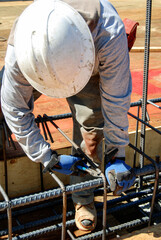 Worker tying reinforcement rebar