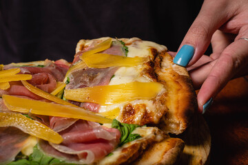 melted mozzarella cheese pizza with dark background