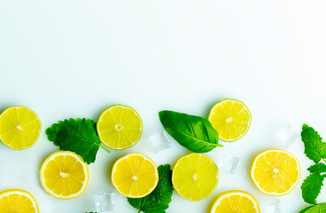 sliced lemon with mint and ice white surface top view