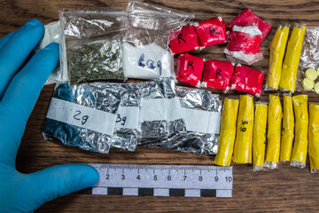 evidence of smuggling traffic: packages of unknown drugs next to the forensic scale