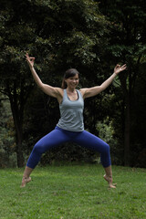 Woman practice Yoga outdoor in the natural park 