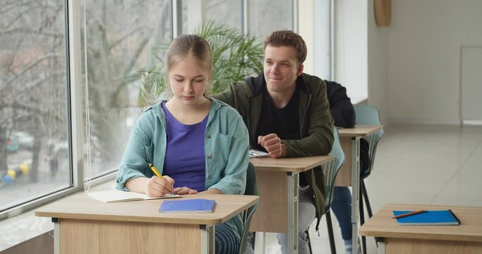 Teenage boy declaring his love to girl at school
