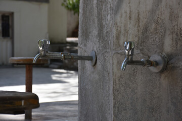 fountain on the wall. Closeup of brass faucet on public water fountain in urban park, Public bronze faucet fountain in old traditional style. city Istanbul