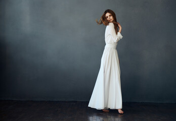 Fototapeta na wymiar pretty woman and white dress glamor and luxury gray background model