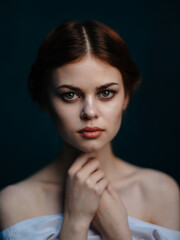 Fototapeta premium Beautiful woman in white dress hairstyle dark background model portrait