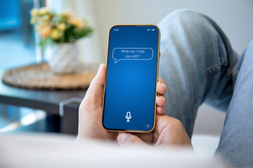 male hands holding phone with app personal assistant on screen