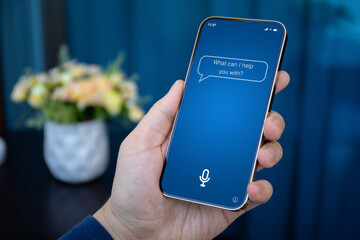 male hands holding phone with app personal assistant on screen