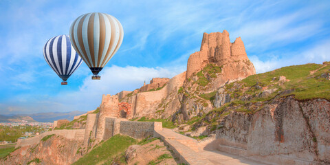 Hot air balloon flying over Ruins of ancient fortress in Van - The old castle of Van - Van, Turkey © muratart