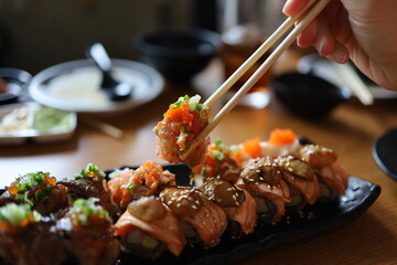 Overhead japanese sushi food. Eating sushi set with chopsticks on restaurant.