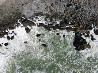 4K Aerial drone photo of rocky shoreline in California