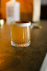 Brown alcoholic cocktail standing on the table
