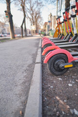 Fototapeta premium Scooter wheels in the parking lot of the city service. Eco-friendly transport
