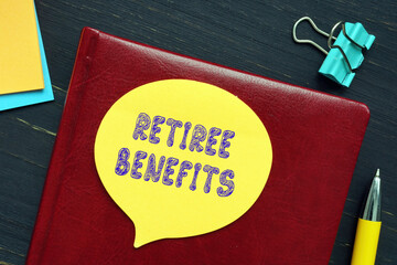  RETIREE BENEFITS phrase on the piece of paper.