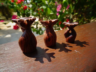 Close-up of three small wooden figurines of Baobab wood (Morondava, Madagascar)