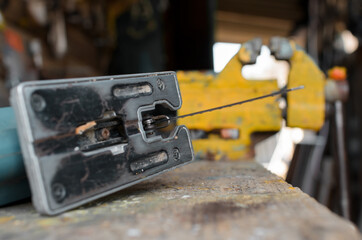 Jigsaw, vise in the barn outside. Close-up, selective focus
