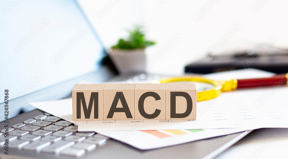 Poster macd - moving average convergence divergence wooden cubes with letters on a laptop keyboardwith char