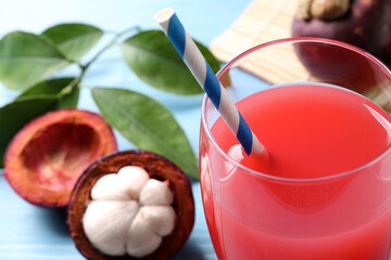 Delicious fresh mangosteen juice in glass, closeup. Space for text