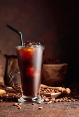 Ice coffee in frozen glass and coffee beans.