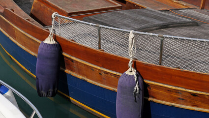 Mooring buoys and fenders on the starboard of the wooden boat