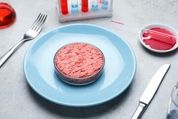 Cultured meat served on light grey lab table