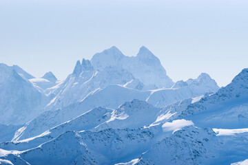 Fototapeta na wymiar Snowy Caucasus mountains Ushba, Schelda, Kogutai in winter, view from Elbrus slope; Kabardino-Balkaria, Russia