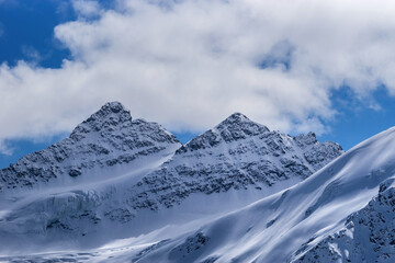 Fototapeta na wymiar Snowy Kogutai mountains in winter day. Great Caucasus Range, Elbrus region, Russia