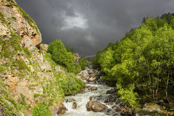 Stormy clouds above mountain river in Russian Caucasus in summer