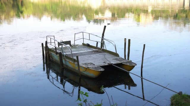small ancient and old boat to navigate the river - raft - Trezzo D adda river , Lombardy - Italy 
