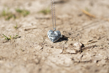 Pendant Best Friend heart necklace shoot outside in a summer day closeup. Selective Focus. High quality photo