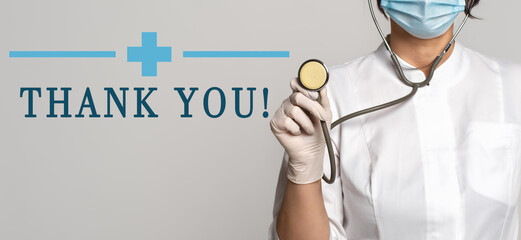 Thank you - concept of text on gray background. Nearby is a cropped view of doctor with stethoscope