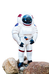 Astronaut stone painted color statue on the rock isolated on white background. Spaceman sculpture on stone