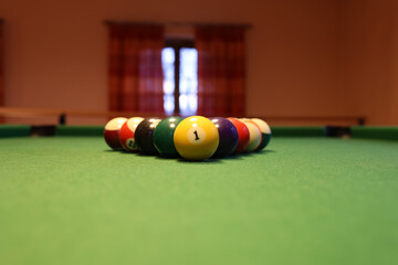 Colored pool balls on a green pool table. Billiard ball with number one