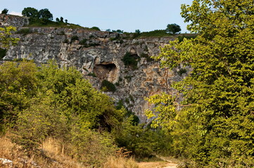 Panorama from the area of ​​Rusenski Lom Nature Park with high vertical limestone cliffs, overgrown with deciduous trees, Nisovo, Bulgaria  