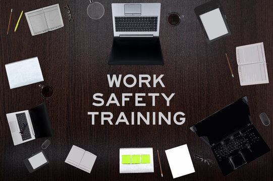 Work Safety Training Concept. Top Layout Of Drawings Of Laptops, Notepads, Coffee, Different Business Stuff On Table Background.