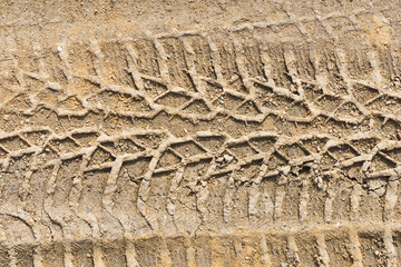Sand tyre mark background. Tire track shape. Trail lines on dry brown sand pattern. Road...