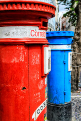 Colorful metallic vintage mail box in red and blue color on the street