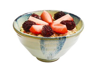 oatmeal porridge for breakfast in a ceramic bowl with blackberry and strawberry isolated on a white background