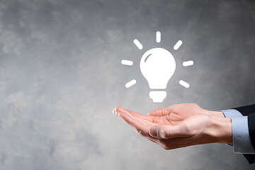 Hand holding light bulb. Smart idea icon isolated. Innovation, solution icon. Energy solutions. Power ideas concept. Electric lamp, technology invention. Human palm. Business inspiration.