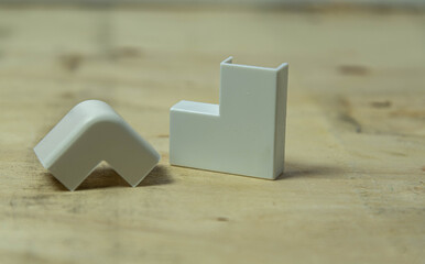 90 degree elbow type electrical connector on wooden background