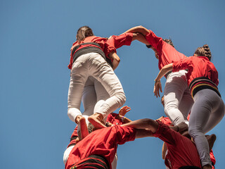 castellers in Catalunya exhibiting at the traditional yearly competition at la Merce celbration on Plaza San Jaume, Barcelona, Spain - obrazy, fototapety, plakaty