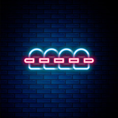 Obraz premium Glowing neon line Teeth with braces icon isolated on brick wall background. Alignment of bite of teeth, dental row with with braces. Dental concept. Colorful outline concept. Vector