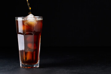 cold iced coffee brew on a black background coffee beans, summer drink