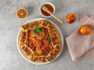 Homemade red blood orange galette with mint and honey. Fruit bakery. Healthy vegetarian dessert....