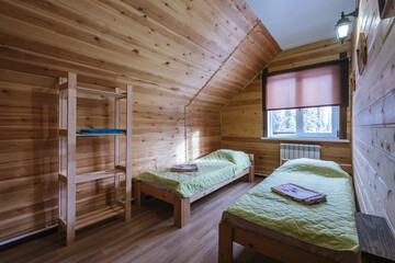 Simple wooden interior of bedroom in mountain resort guesthouse