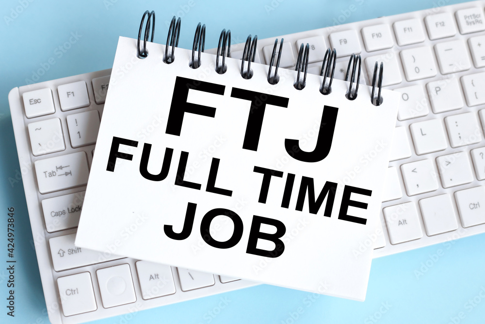 Aufkleber full-time job message. ftj. time to restart. text on white notepad paper on white keyboard
