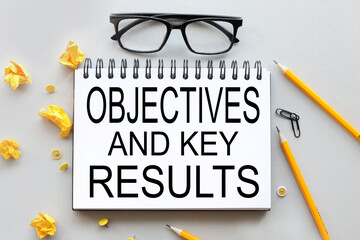 OBGECTIVES AND KEY RESULTS .OKR. text on white paper on gray background